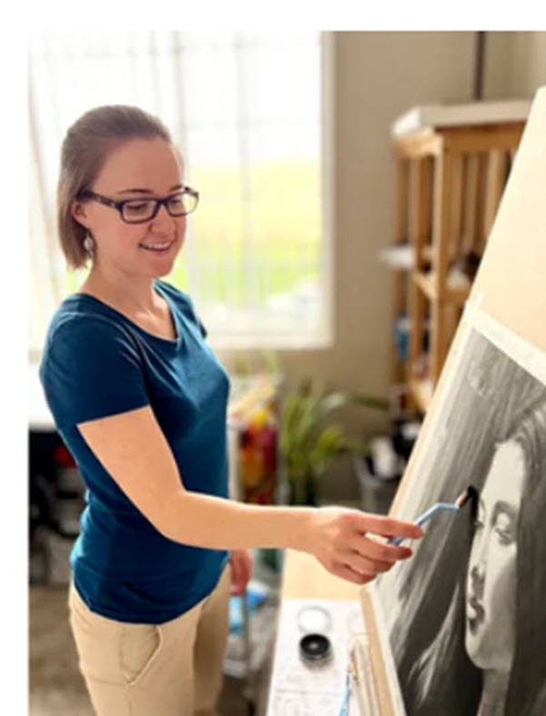 Andrea Walker painting at an easel